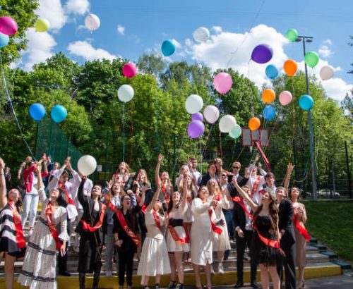 istockphoto-1360147874-612×612 Russia, Moscow, May 2021. The central square, the school holiday last bell. Graduates of school with balls.